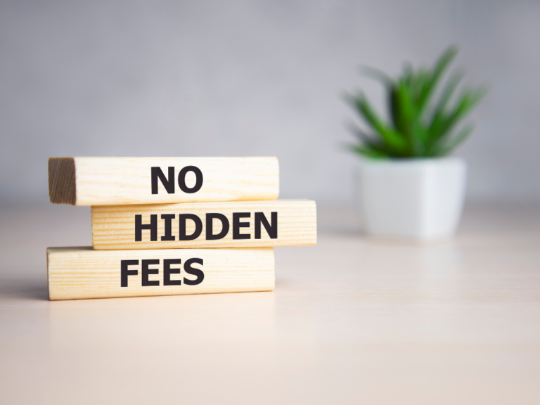 Three stacked wooden blocks on a light-coloured surface with the words "NO HIDDEN FEES" printed on them
