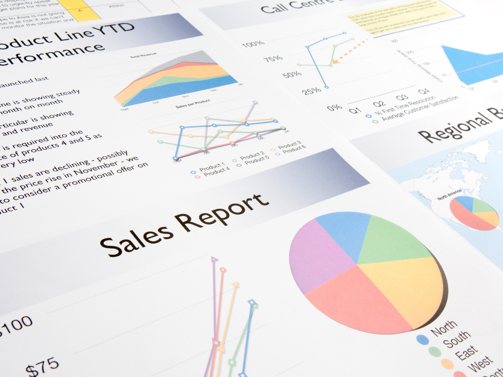 A "Sales Report" document spread across a surface